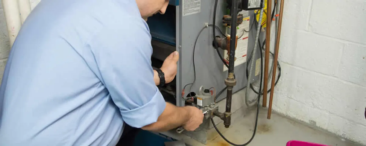 Furnace repair technician inspecting and servicing a home heating system in Savannah, GA