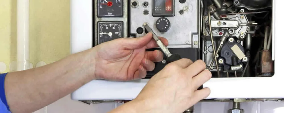 Heating repair technician adjusting boiler controls and components in Savannah, GA