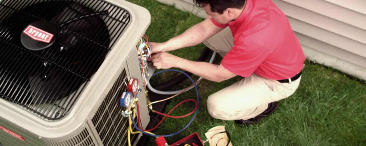 HVAC technician servicing an outdoor air conditioner unit in Savannah, GA