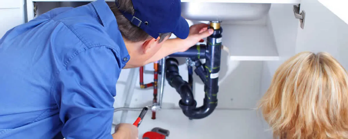 Plumber repairing under-sink drain pipes and fittings in Savannah, GA